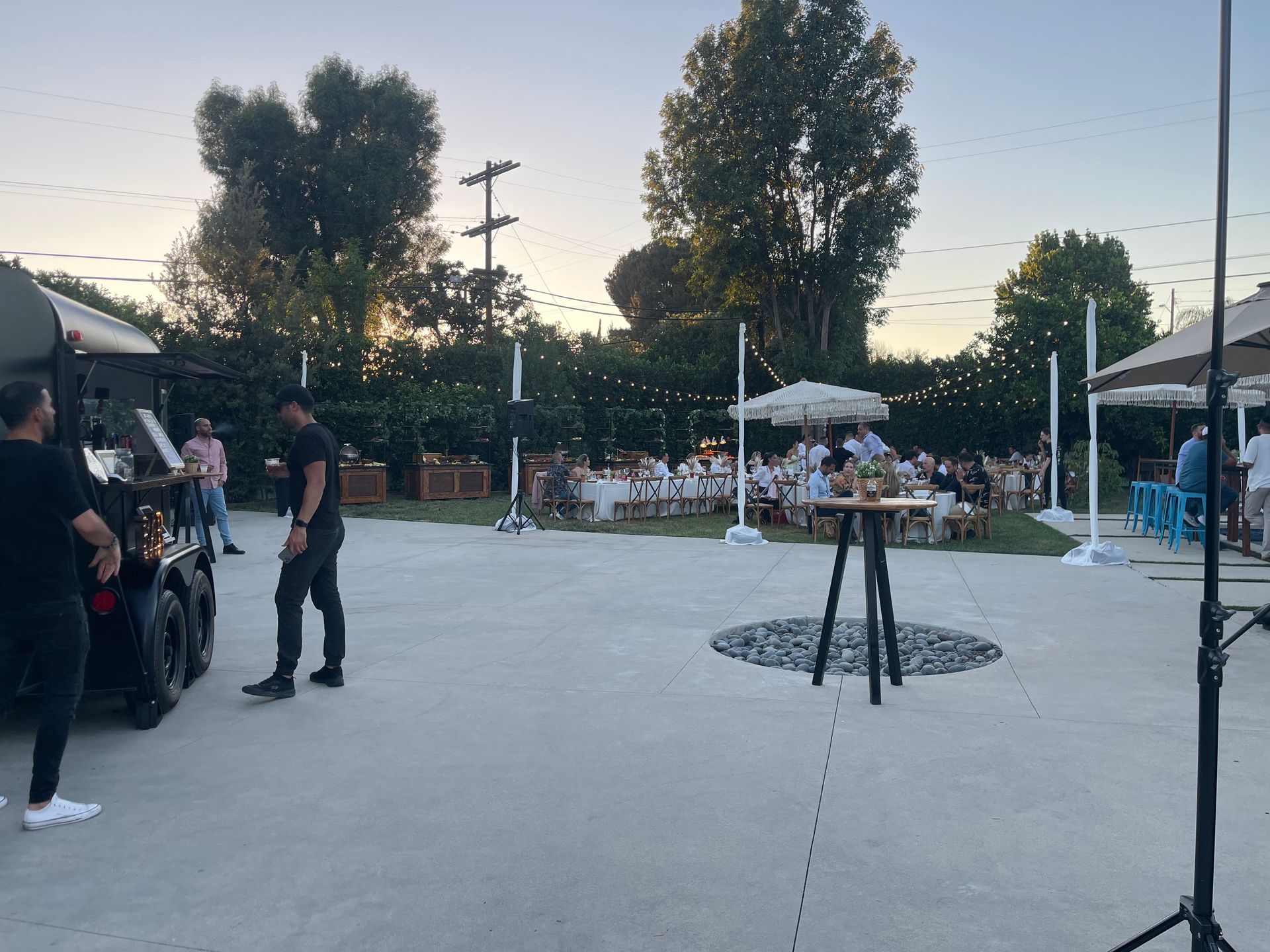 A group of people are standing in a parking lot.