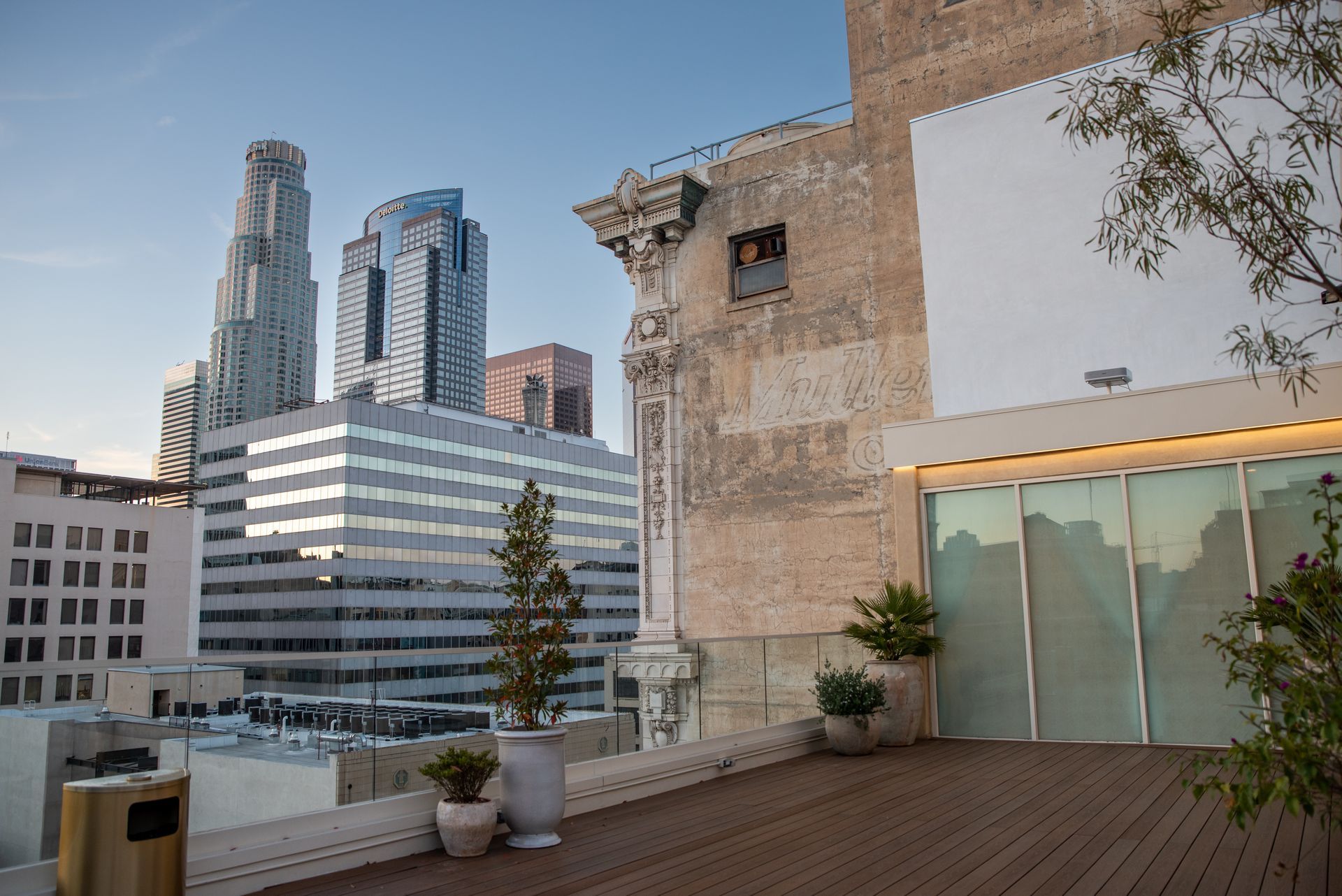 A rooftop deck with a view of a city skyline