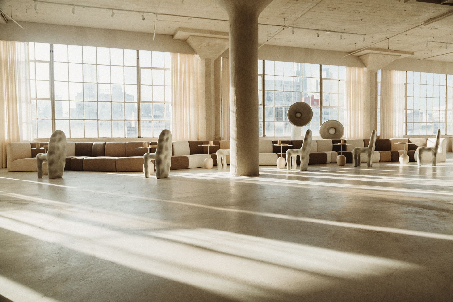 A large room with a lot of windows and furniture