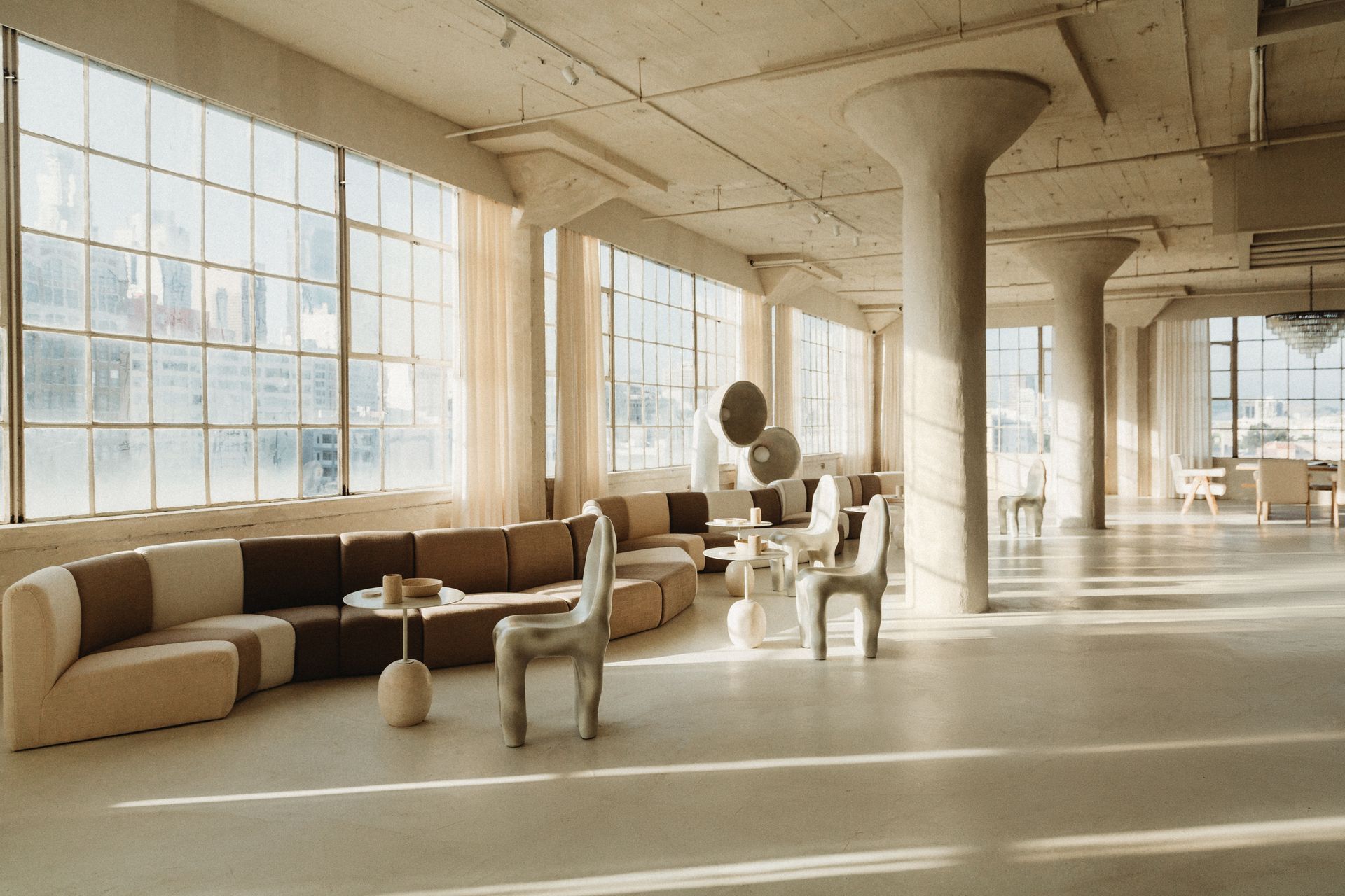 A large room with a lot of windows and furniture