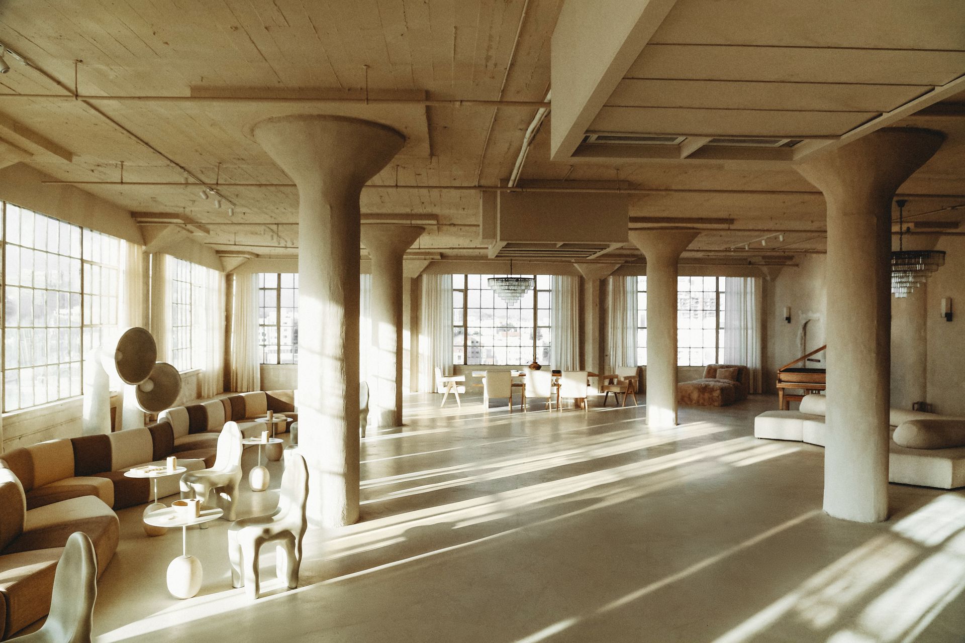 A large room with a lot of furniture and columns