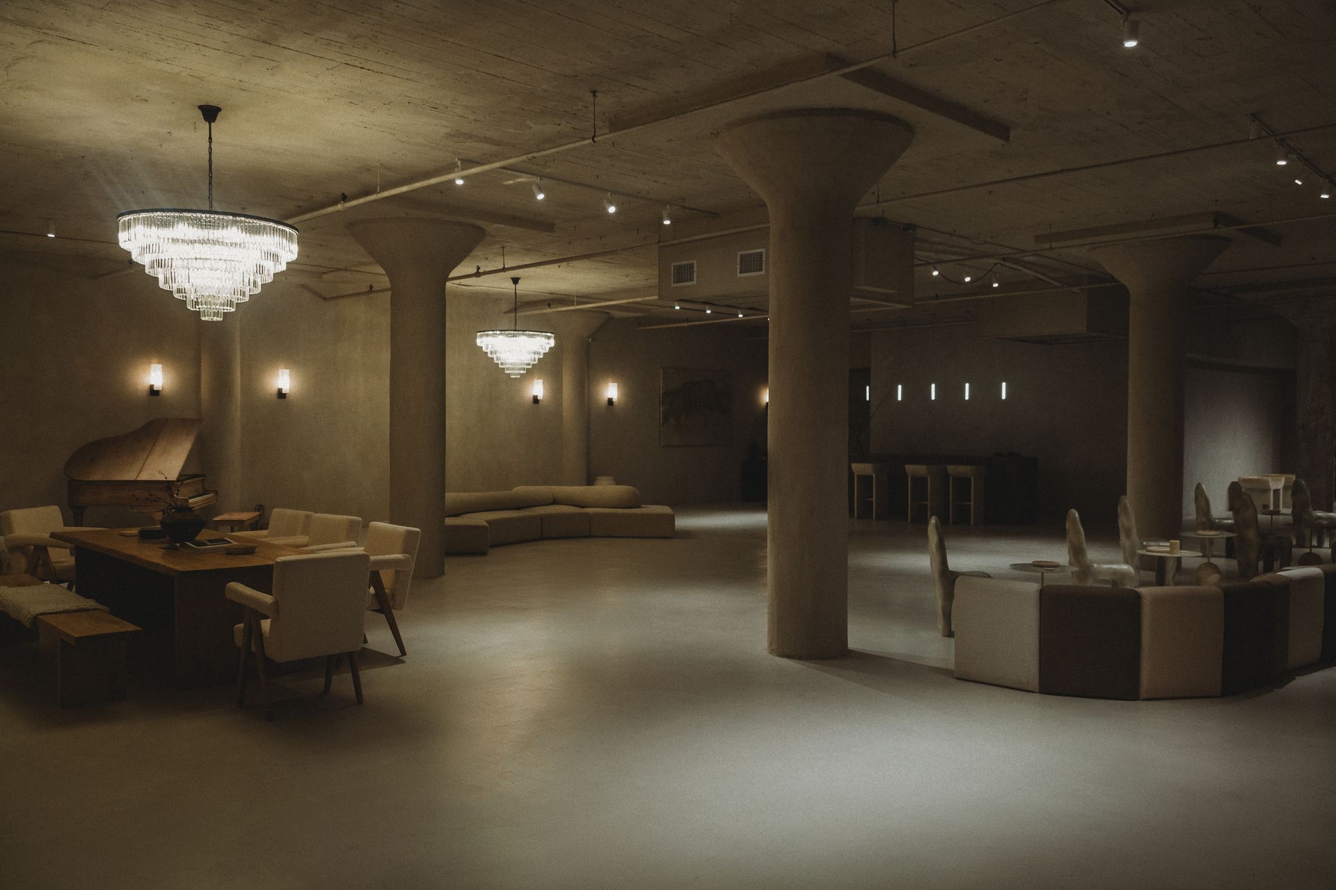 A large room with a table and chairs in it