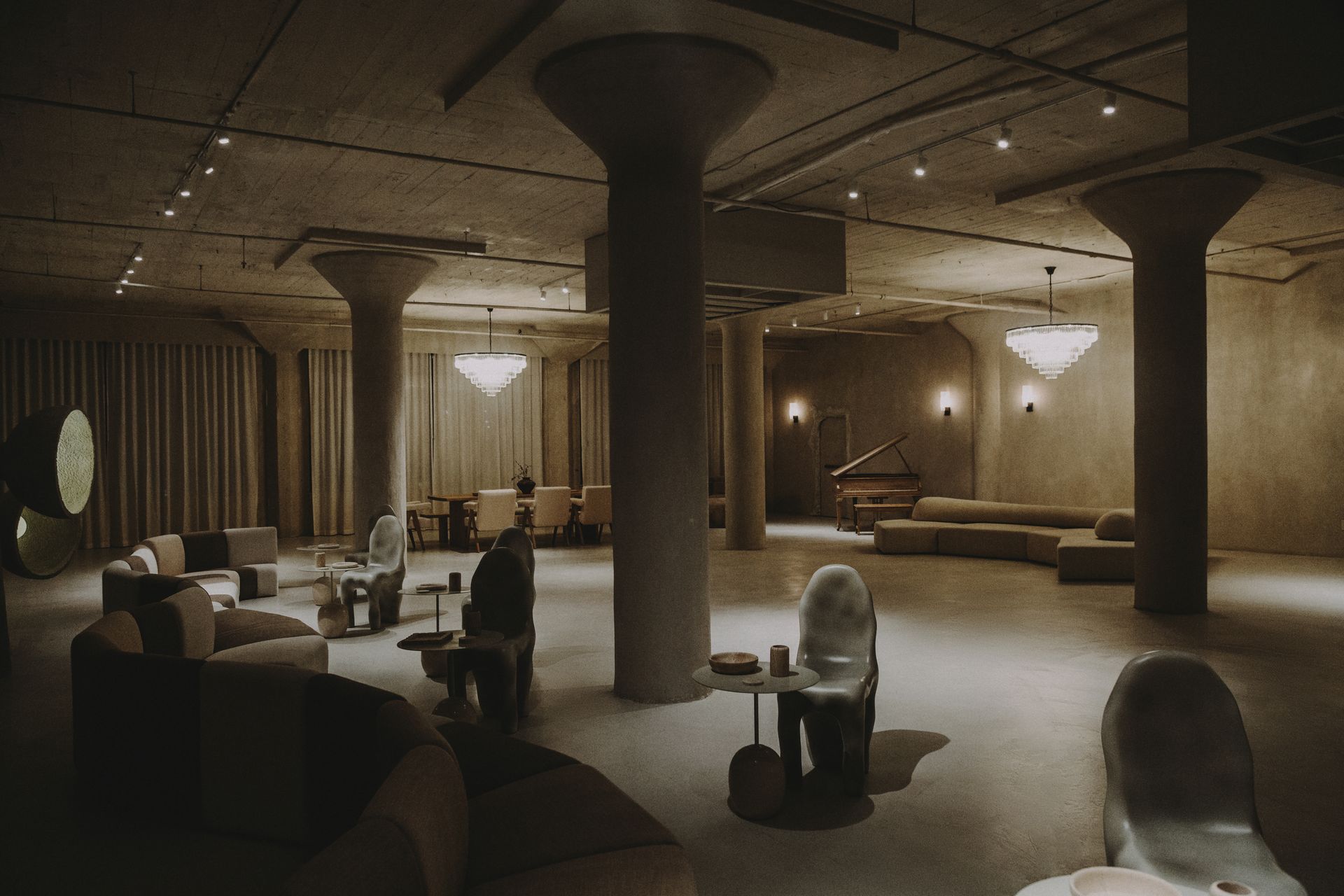 A large room with a lot of furniture and columns