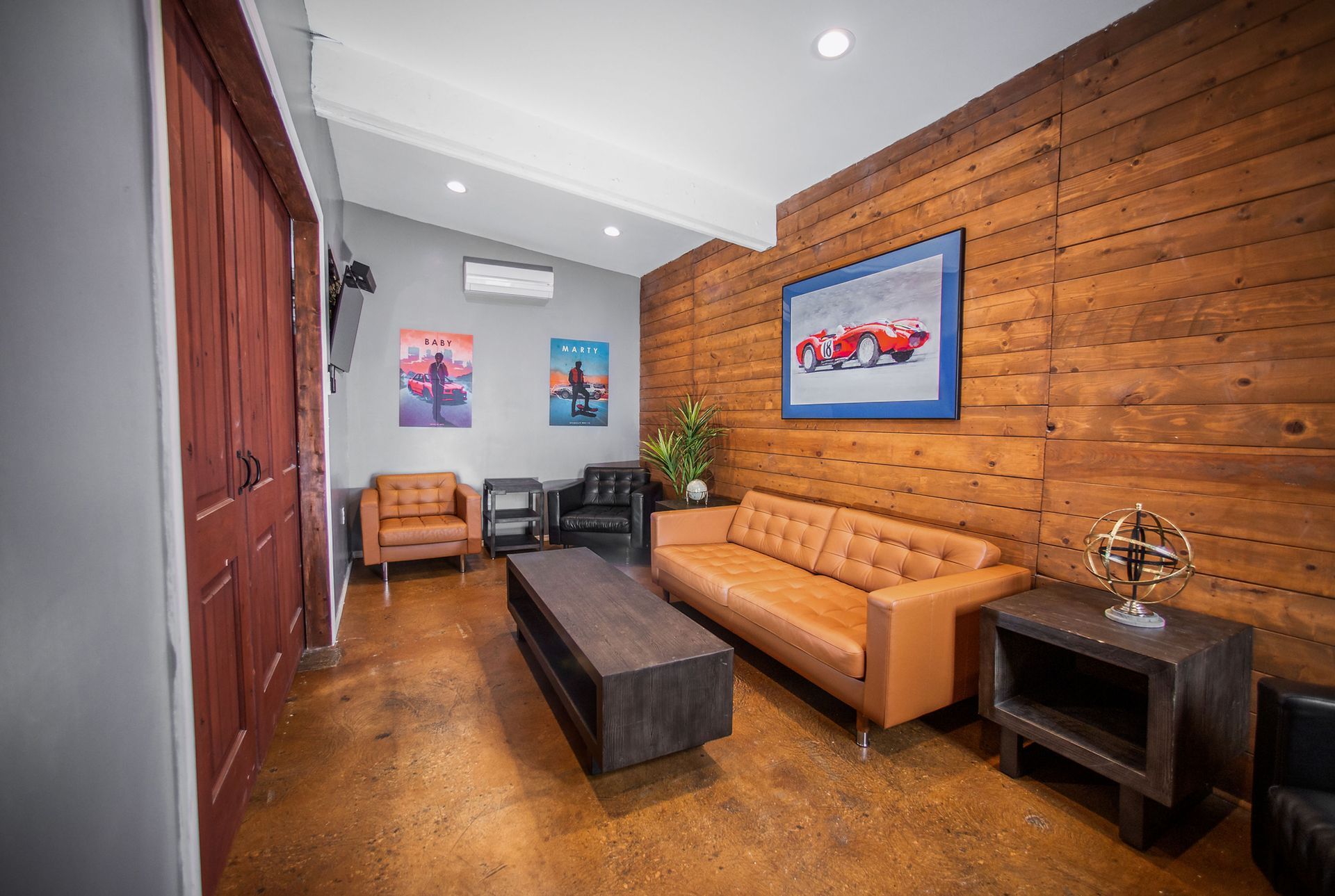 A living room with a couch , chairs , and a coffee table.