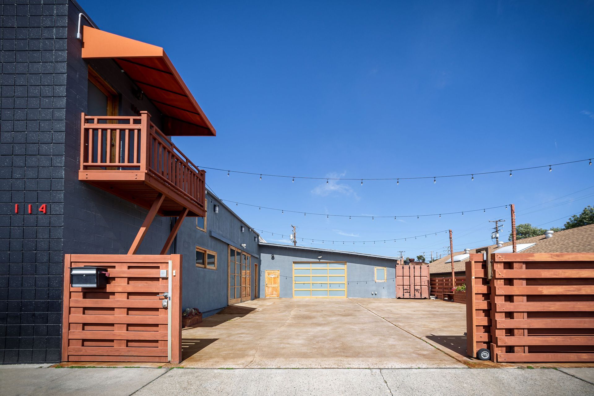 A building with a balcony and a fence in front of it