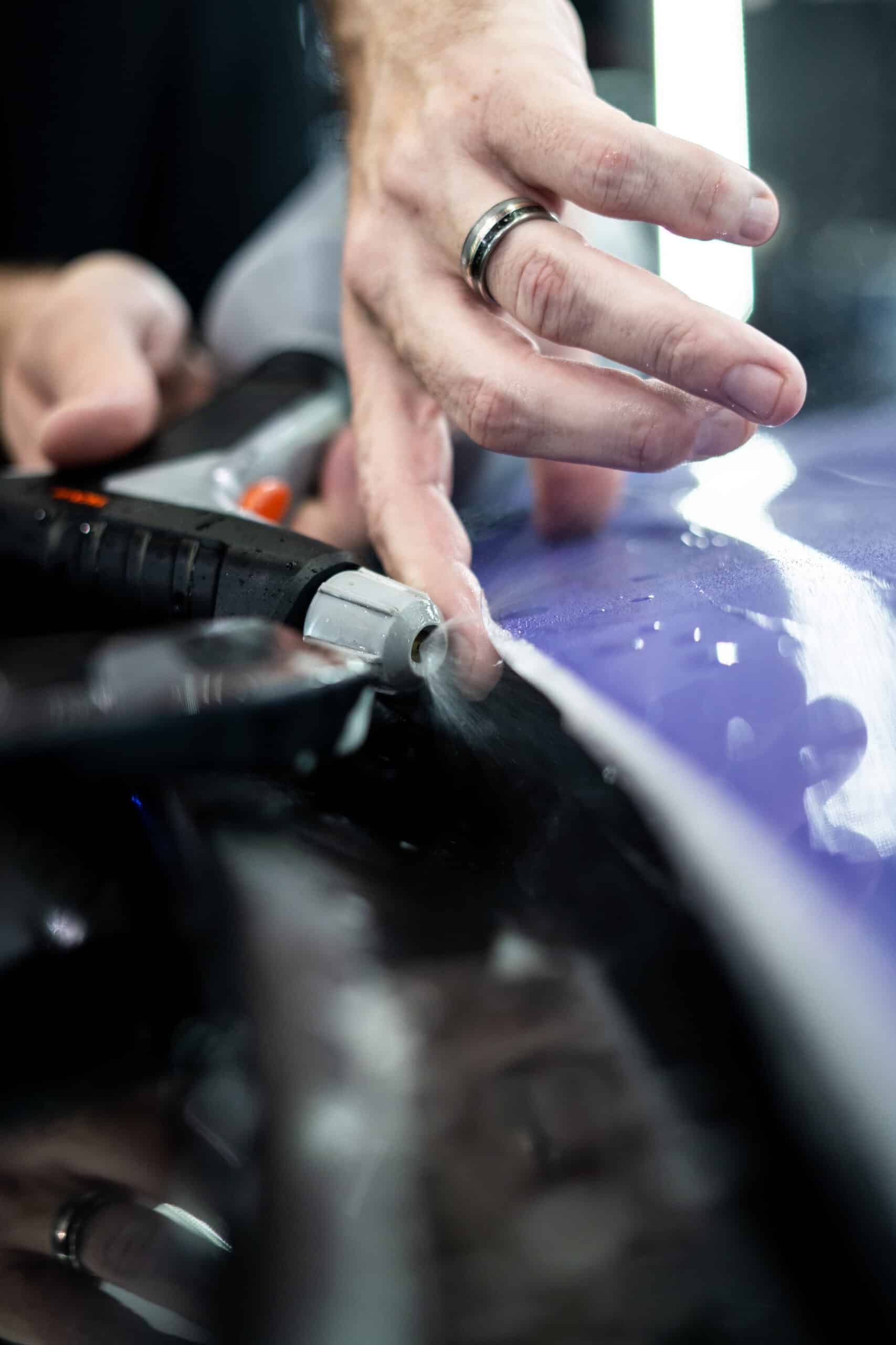A close up of a person 's hand holding a tool.