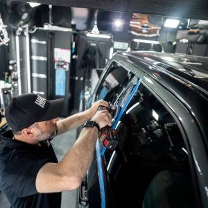 A man is working on a truck in a garage.