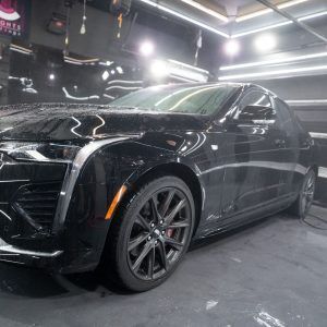 A black car is parked in a garage.