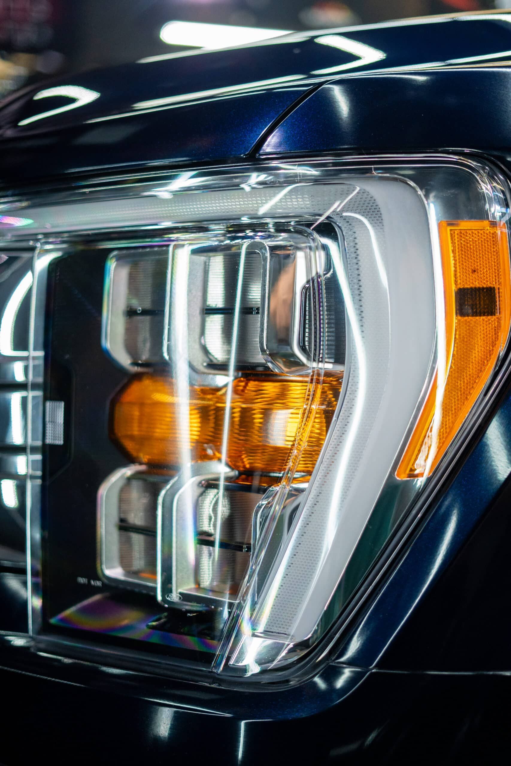 A close up of a headlight on a black car.