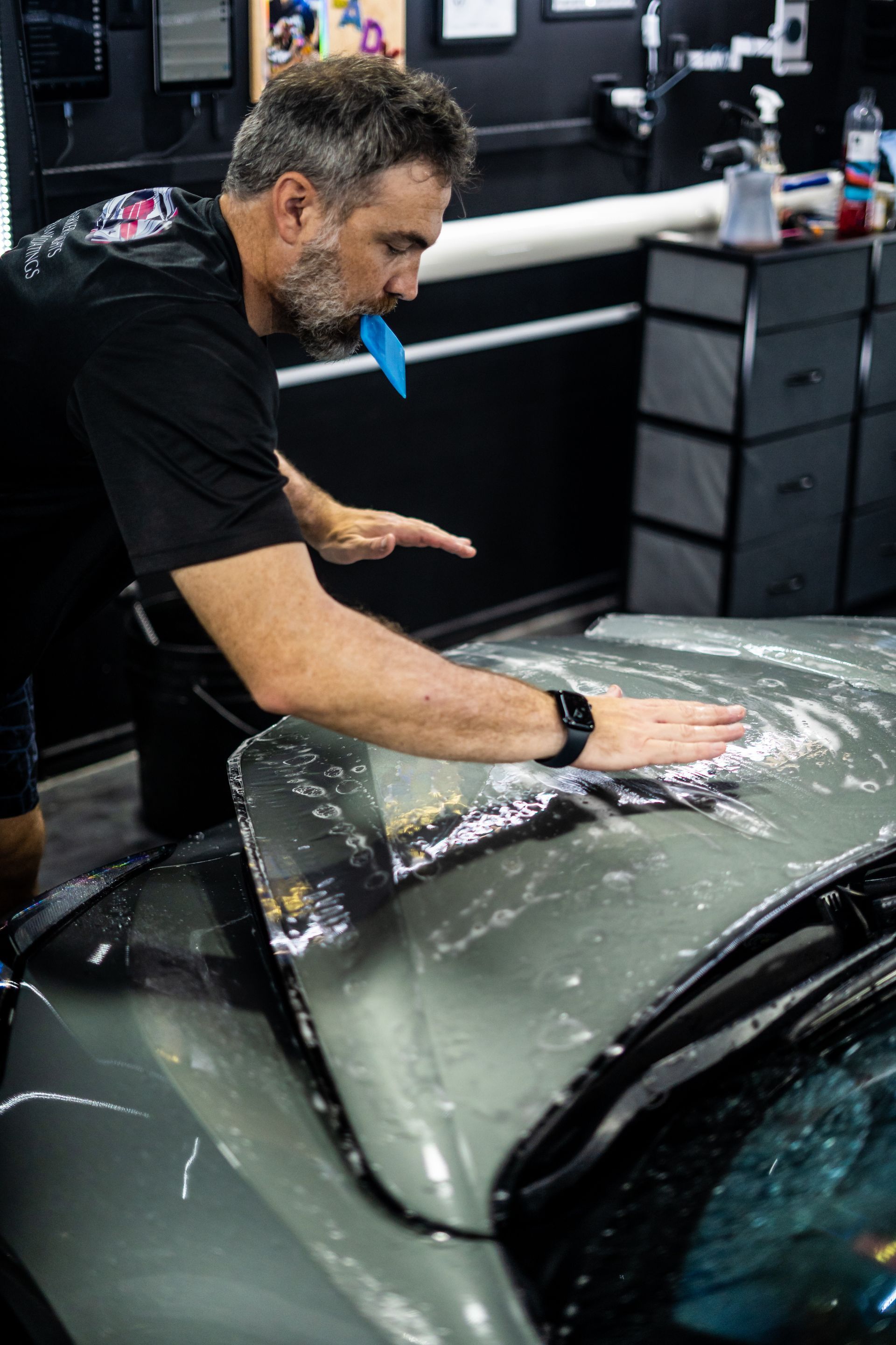paint protection film installation on green car