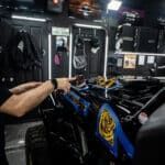 A man is working on a motorcycle in a garage.
