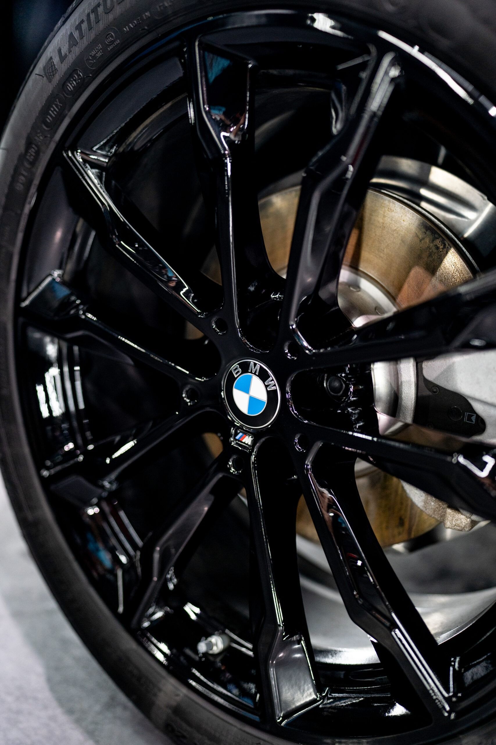 A close up of a black bmw wheel