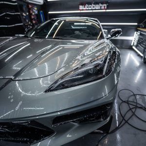 A silver sports car is parked in a garage.