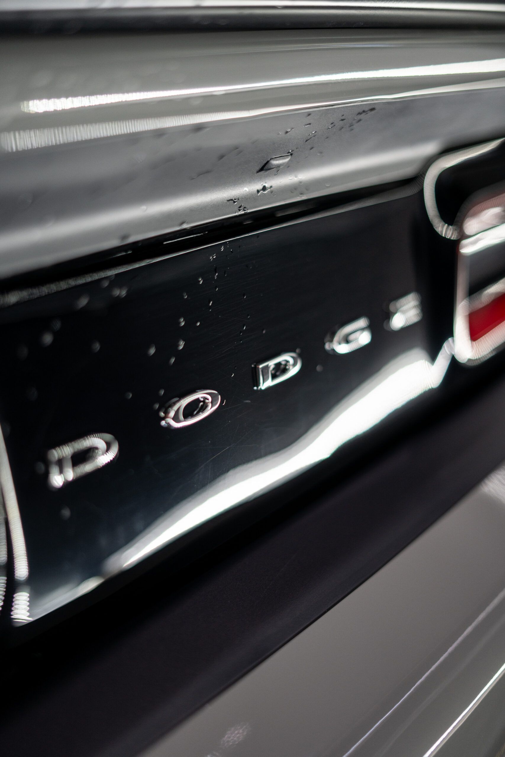 A close up of a dodge emblem on the back of a car