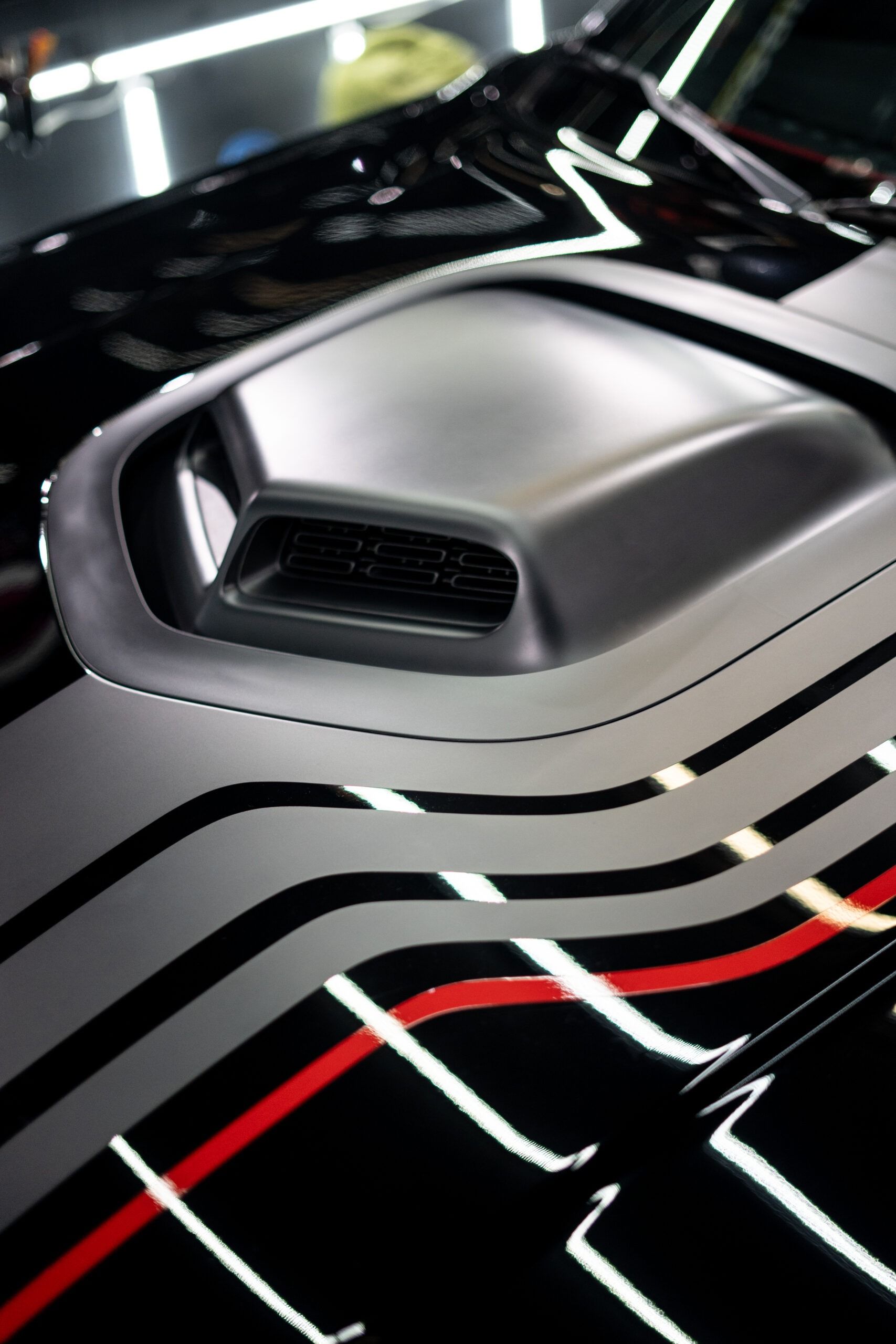 A close up of the hood of a black car