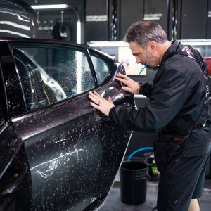 A man is working on a car in a garage.
