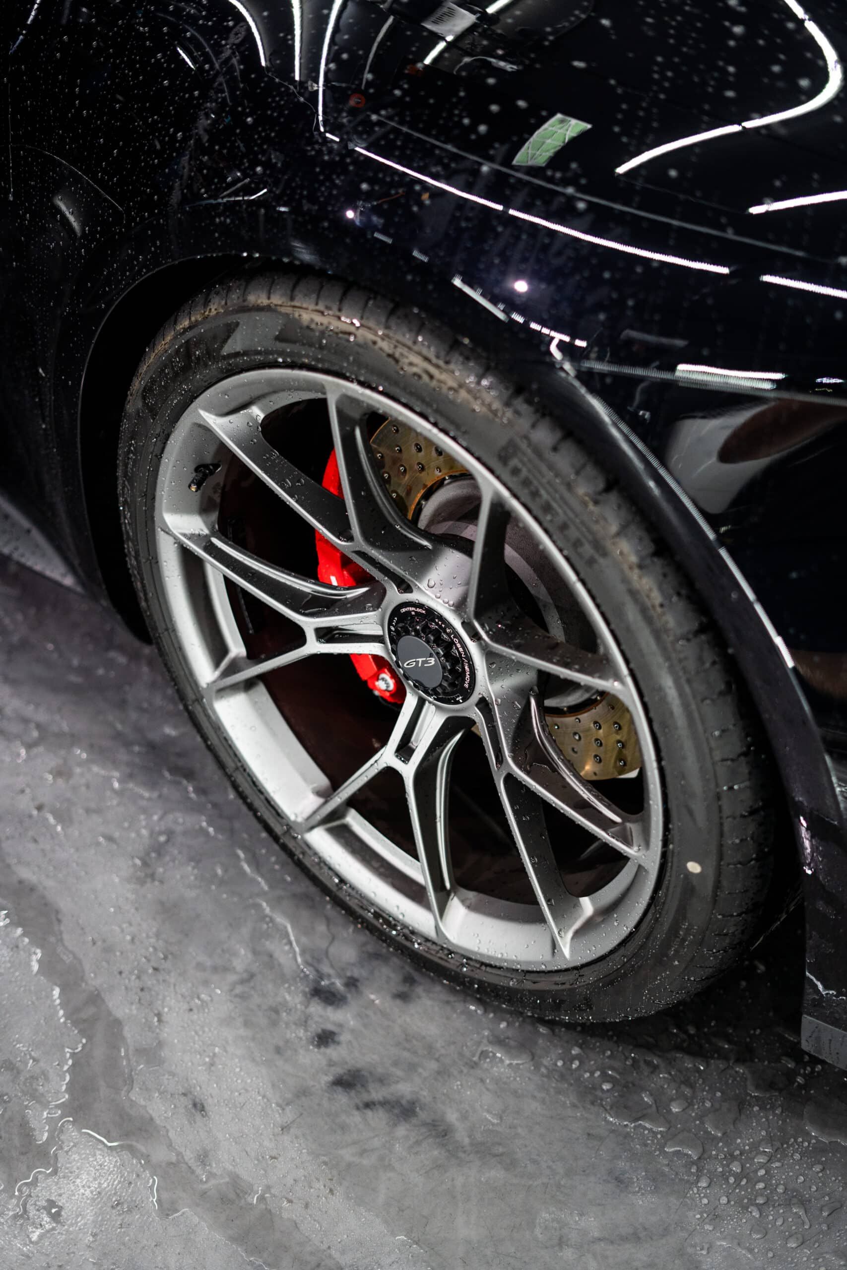 A close up of a car wheel with a tire on it.
