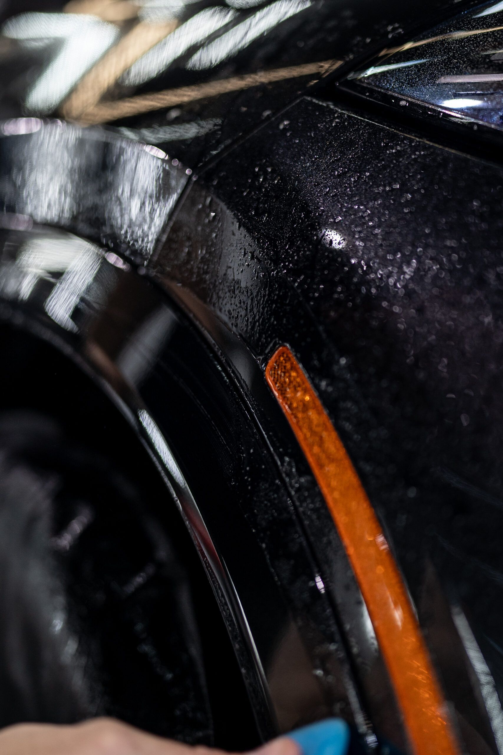 A close up of a person cleaning a car fender