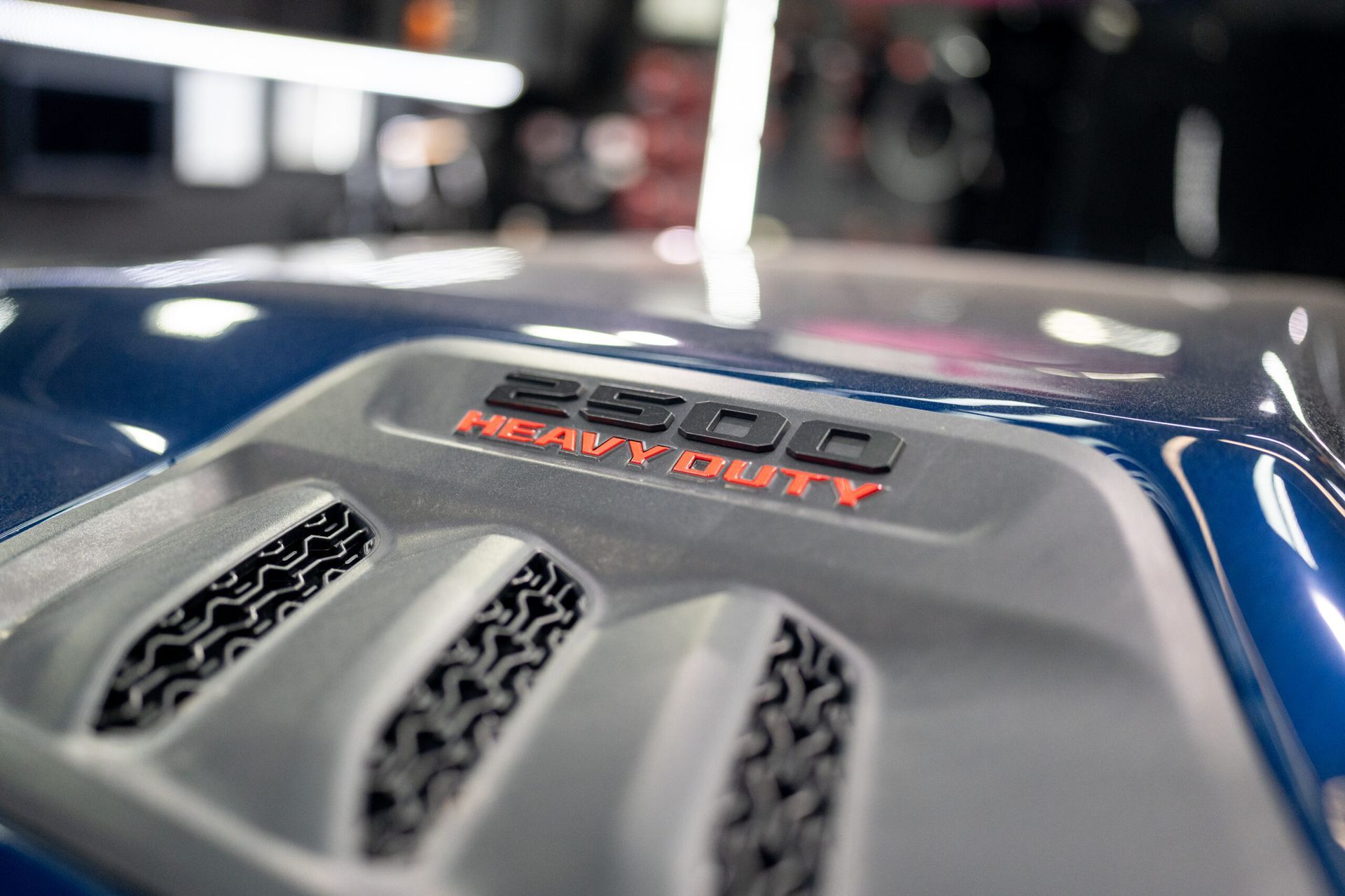 A close up of the engine of a blue truck.