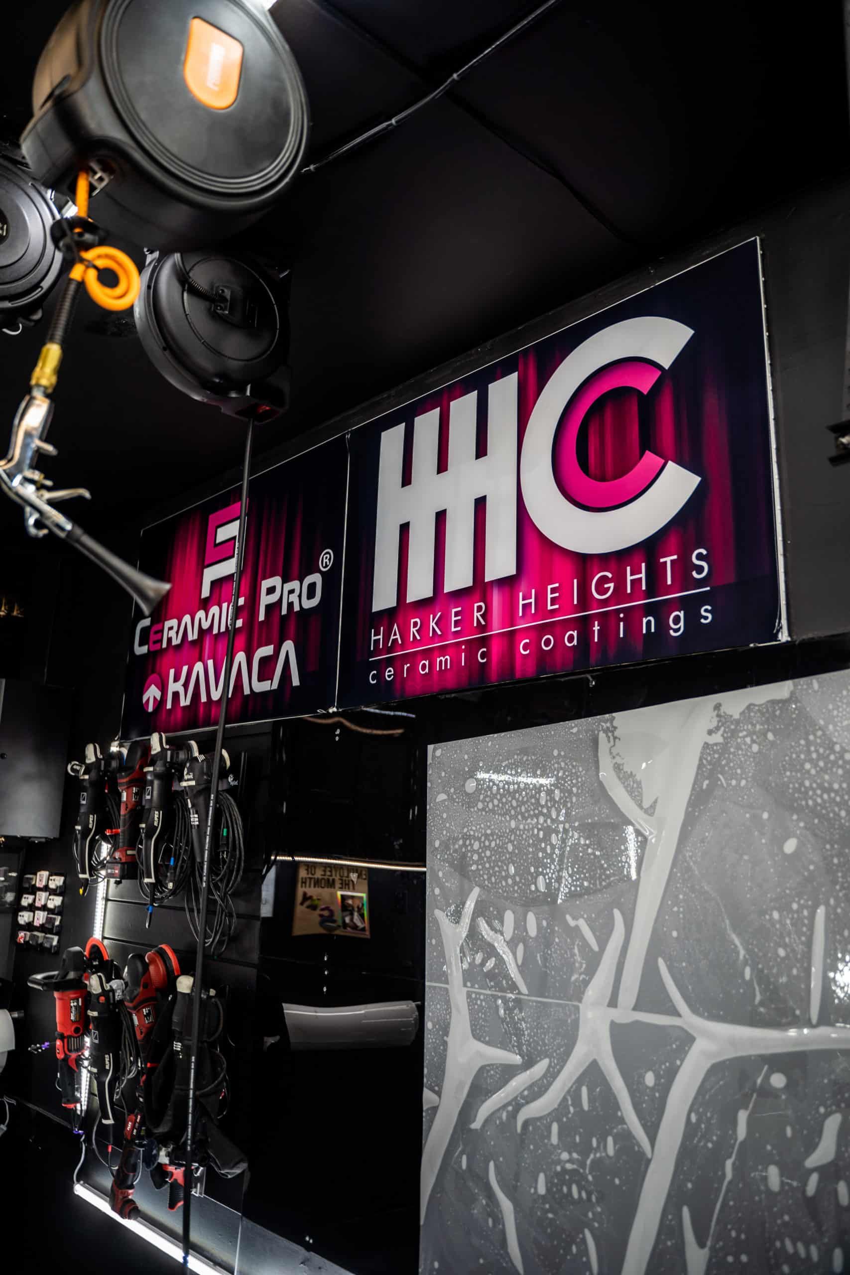 A sign that says hhc hangs from the ceiling of a room