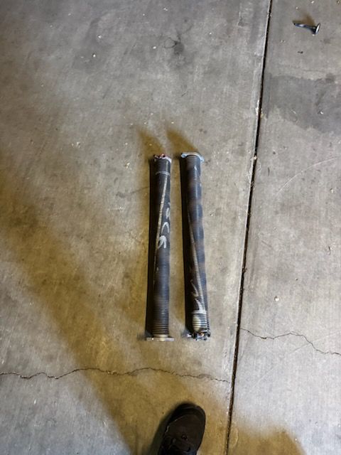 Two cylindrical objects, possibly exhaust pipes, on a concrete floor.