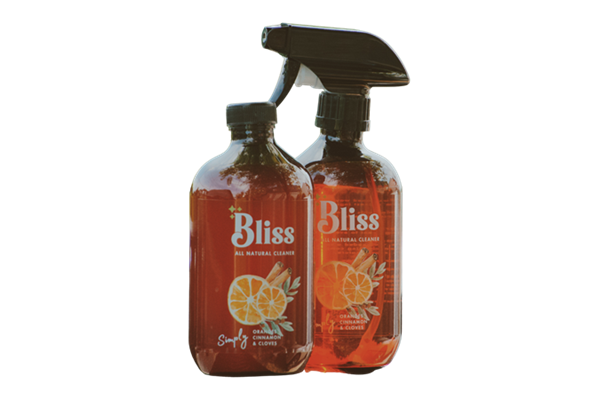 Two bottles of bliss orange clove and cinnamon on a white background