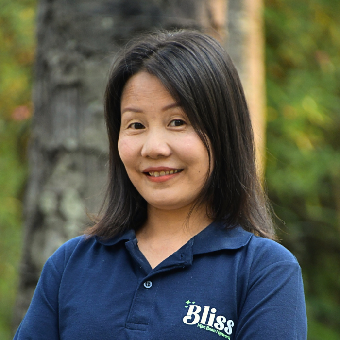 A woman wearing a blue shirt that says bliss