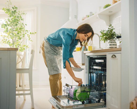 Woman Using a Dishwasher Machine — Jacksonville, FL — Appliance Doctors Woman Using a Dishwasher Machine — Jacksonville, FL — Appliance Doctors