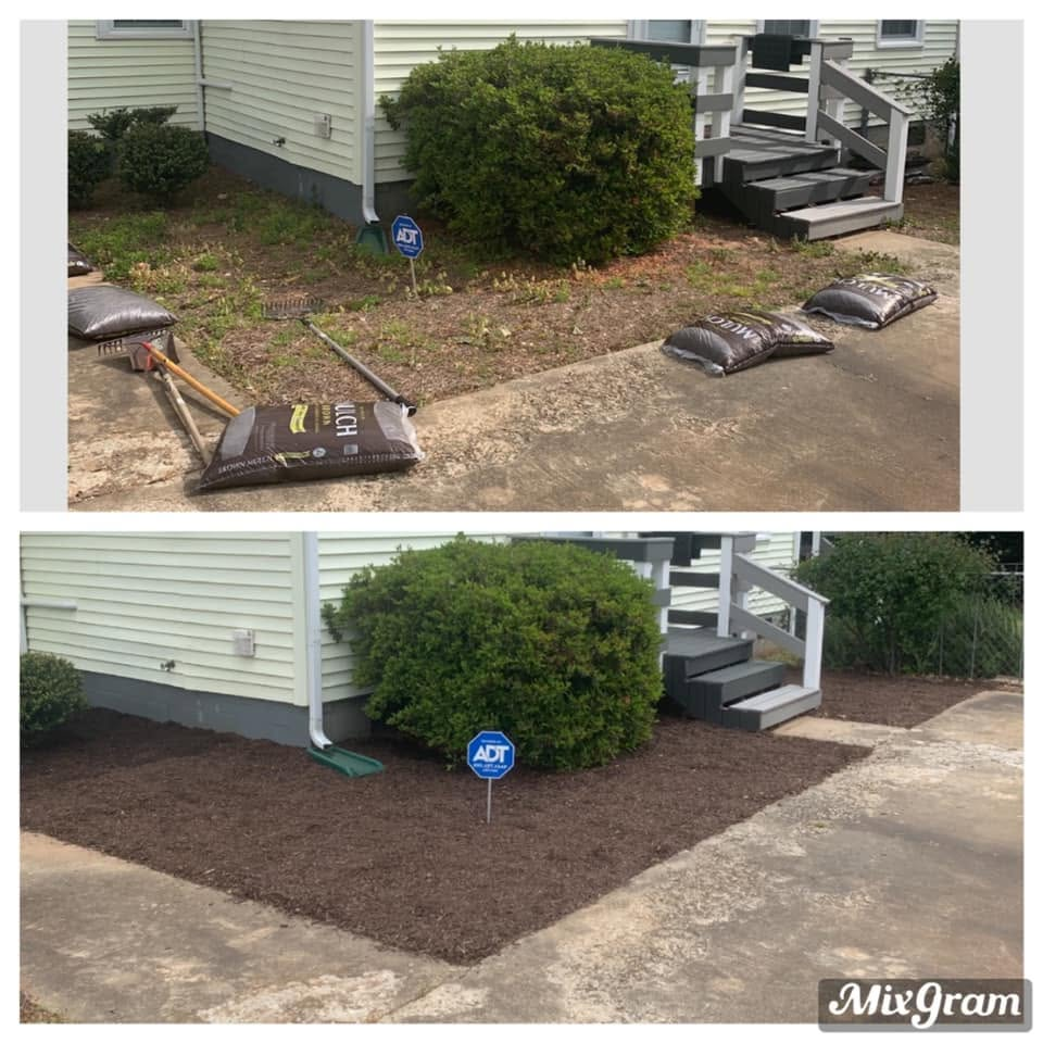Lawn edging project beside a house, with bags of mulch and freshly spread dark mulch around a shrub.
