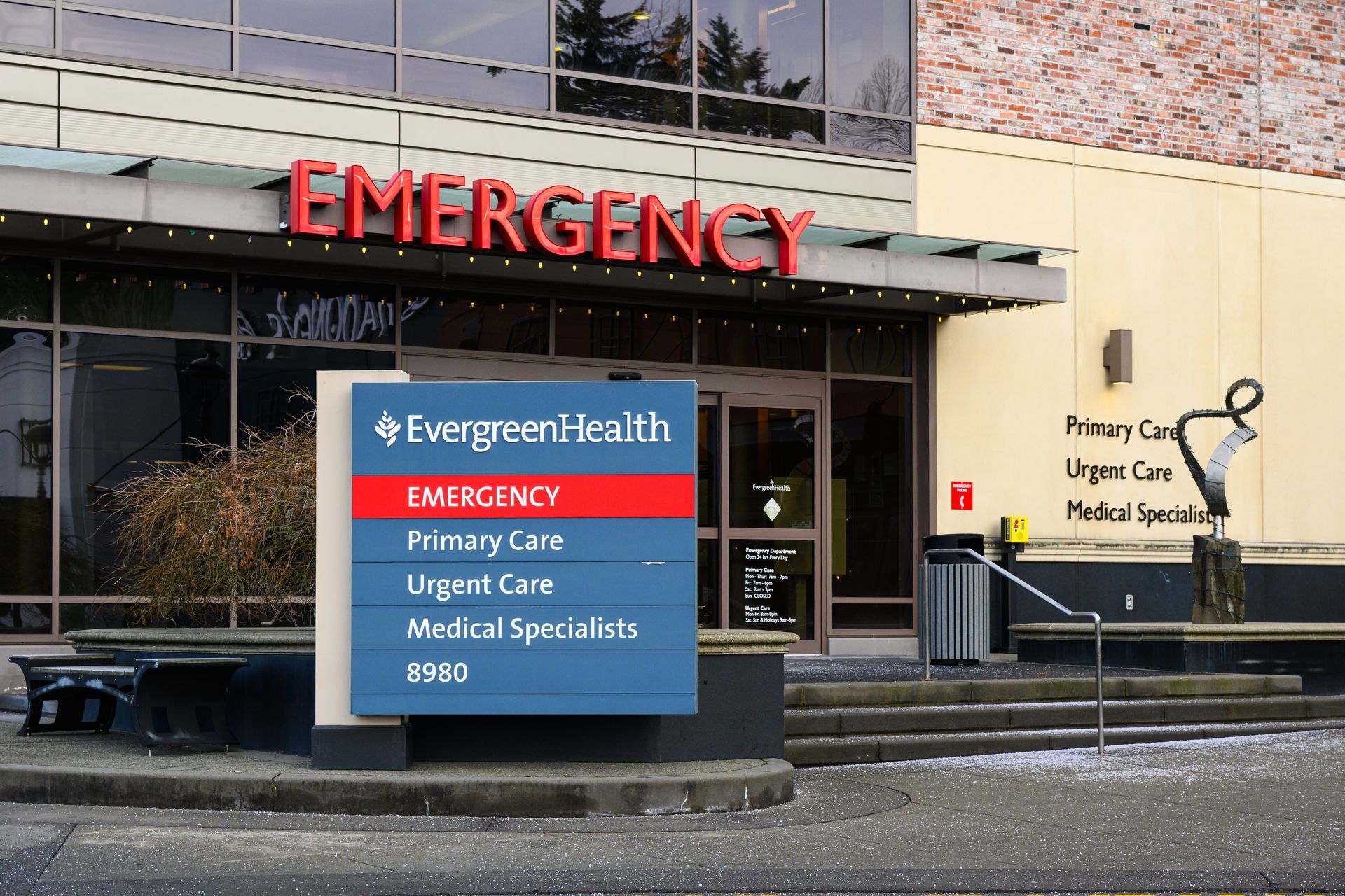 An evergreen health emergency room with a sign in front of it