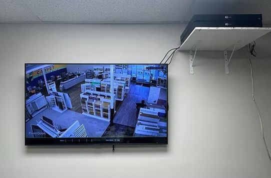 A large flat screen tv is hanging on a wall.