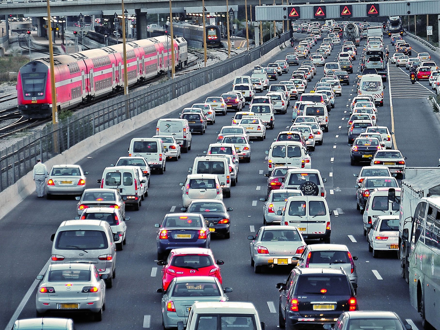 Traffic Jam on Highway with A Train on Adjacent Tracks