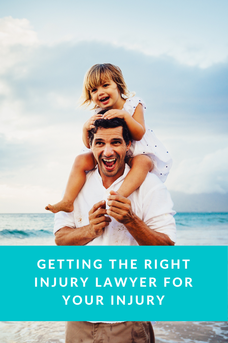 Man Holding a Laughing Child on His Shoulders at The Beach