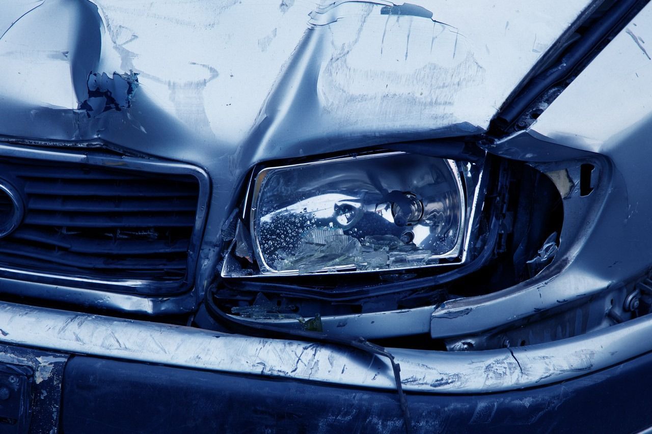 Damaged Silver Car Front End; Crumpled Hood, Broken Headlight