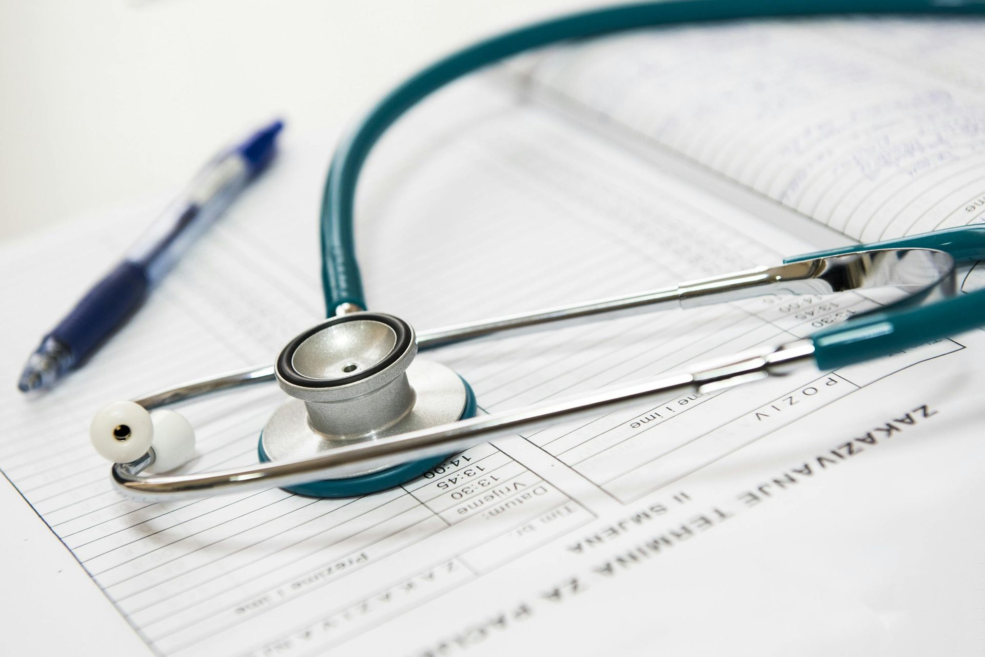 Stethoscope and pen on top of medical forms — Bespoke Legal Group In Southport, QLD