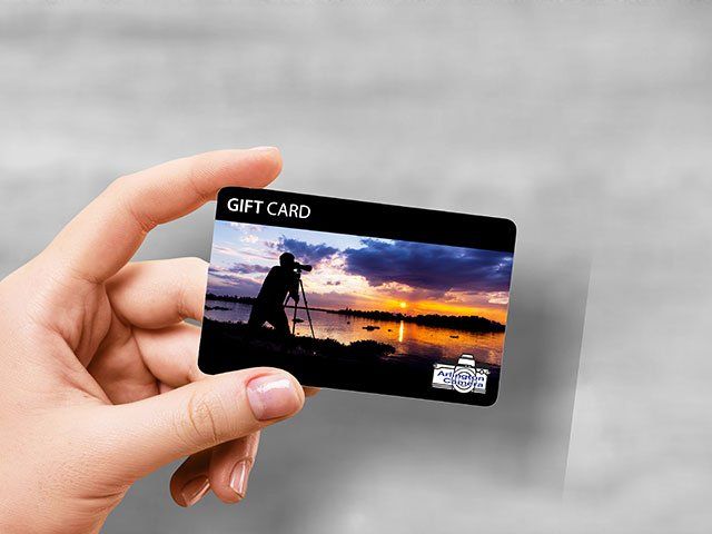 Hand holding a Arlington Camera gift card