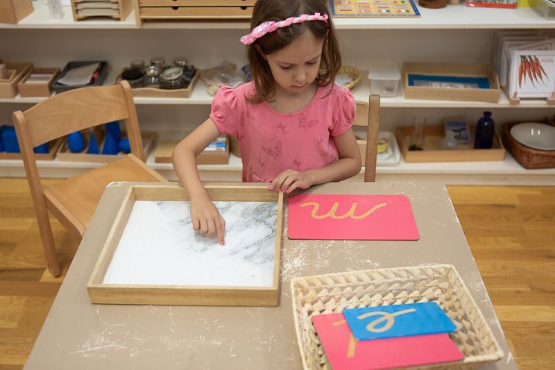 Montessori child practising to write alphabets