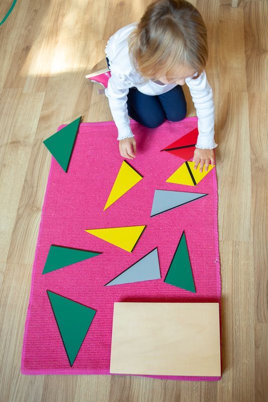 Montessori child matching colorful shapes
