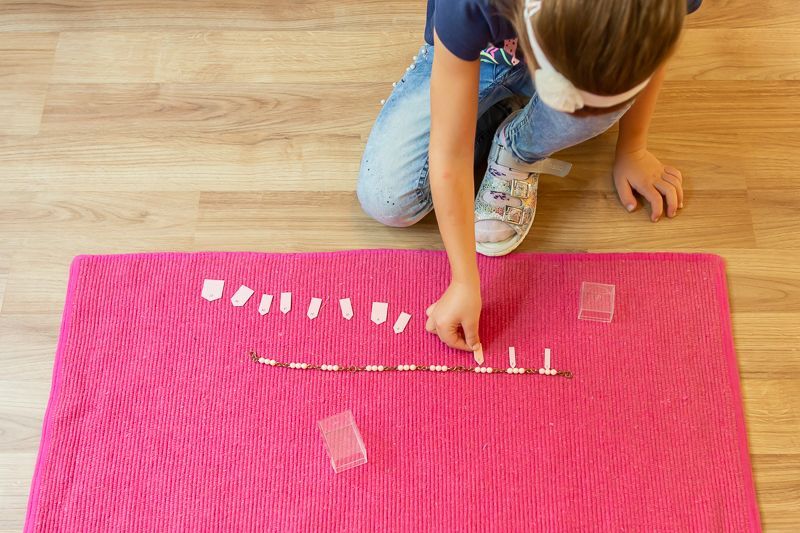 Montessori child working with math materials