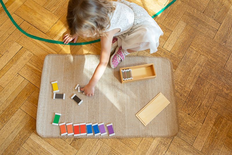 Montessori child playing with colorful shapes