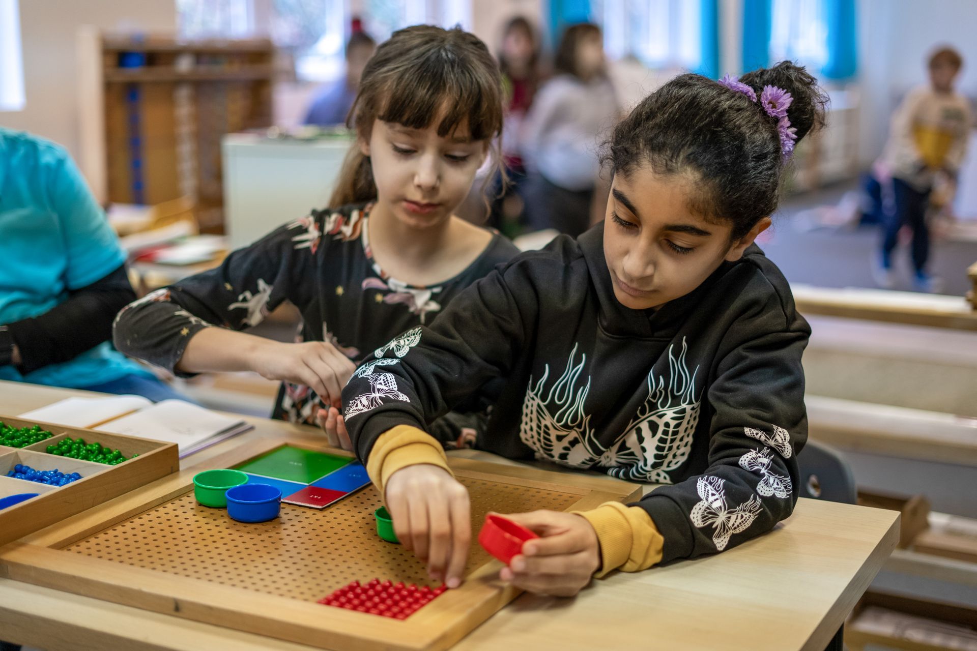 Montessori children working with math materials