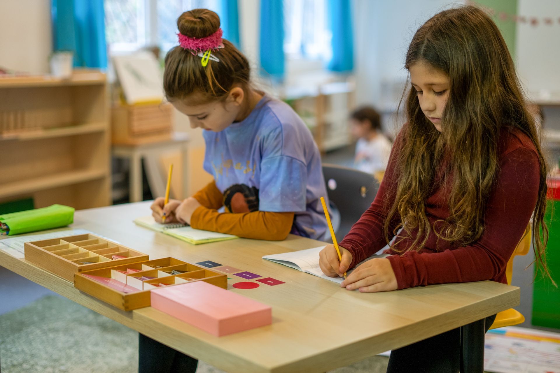 Montessori children working with language materials