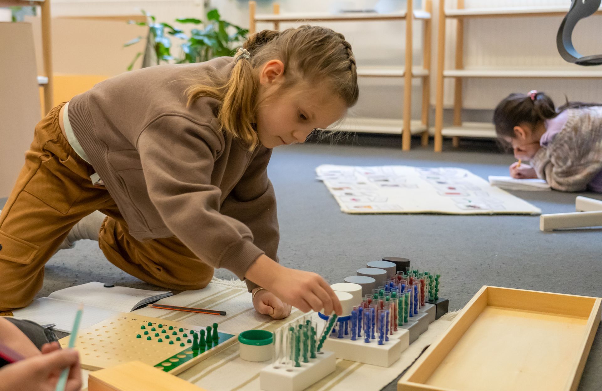 Montessori child working with math materials