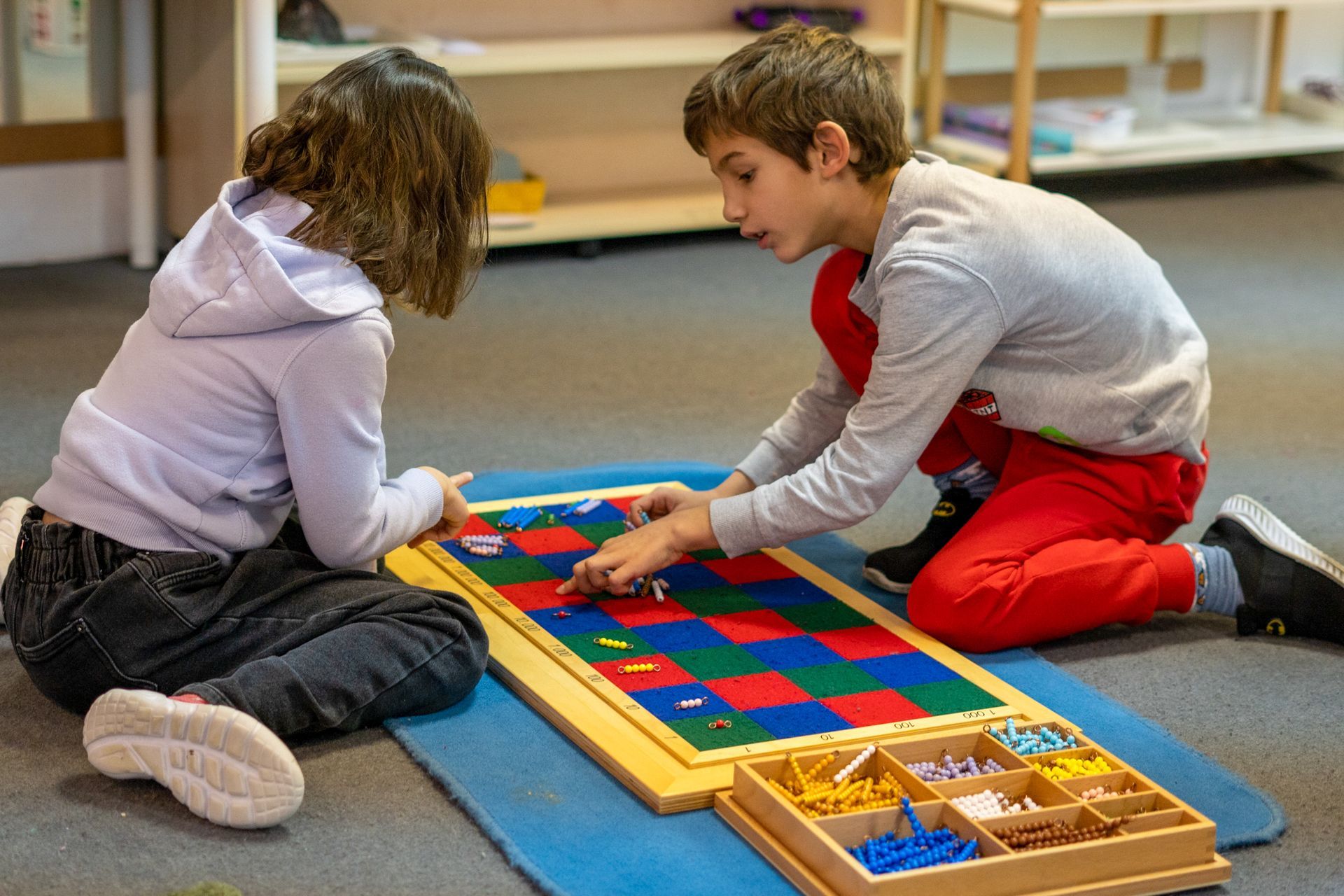 Montessori children working with math materials
