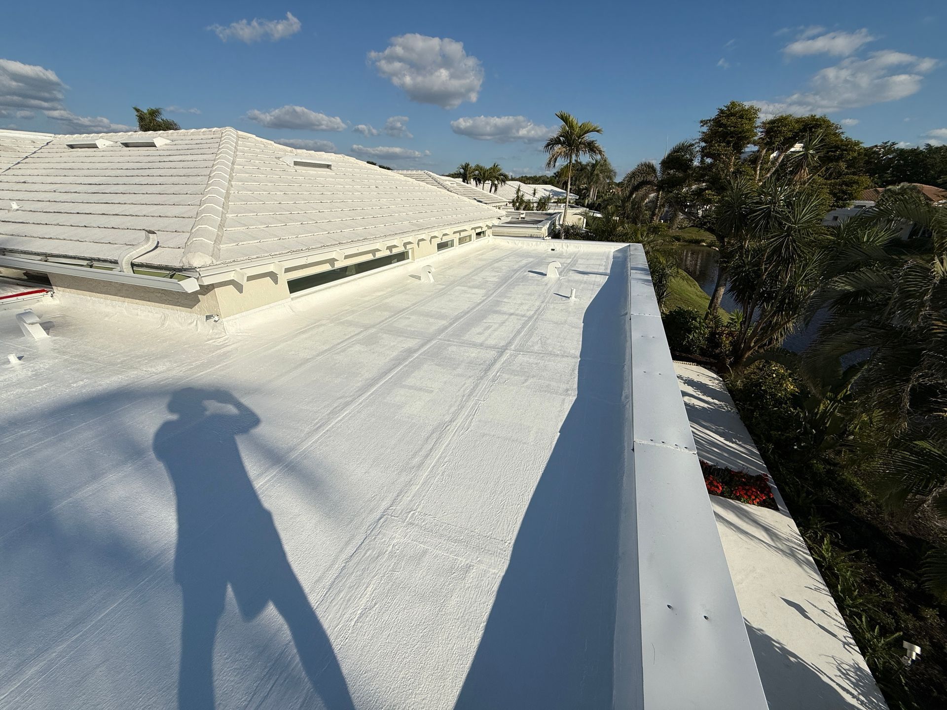 Roof under repair, showing exposed underlayment and terracotta tiles. Roof under repair, showing exposed underlayment and terracotta tiles.