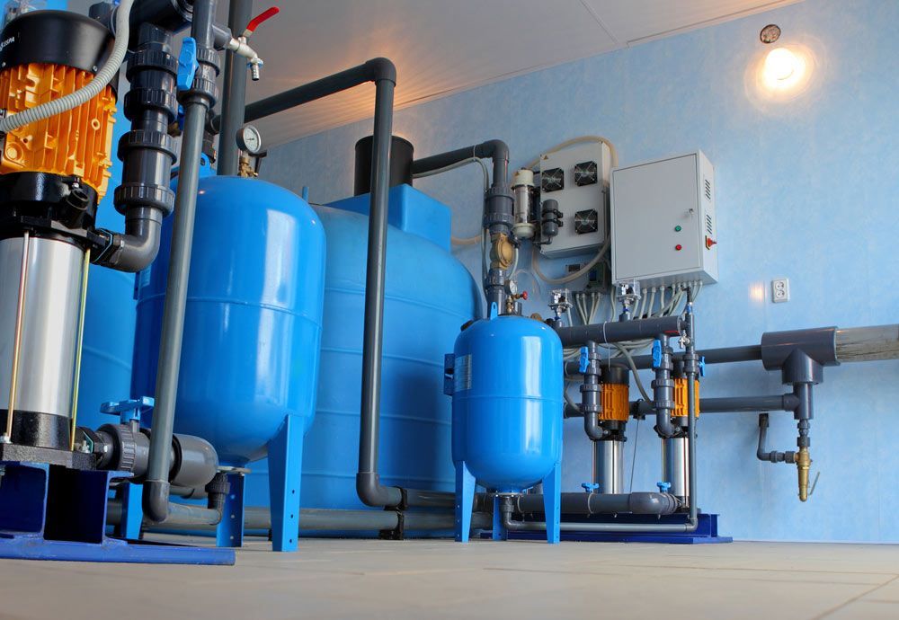Blue Water Treatment Equipment, Including Tanks, Pipes, and Control Panels, in a Utility Room — Keyeng in Slade Point, QLD