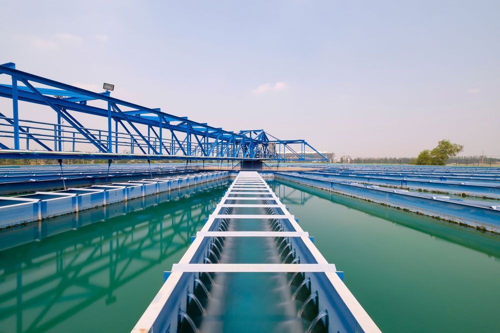 Blue Water Treatment Plant With Rows of Tanks and a Bridge — Keyeng in Slade Point, QLD
