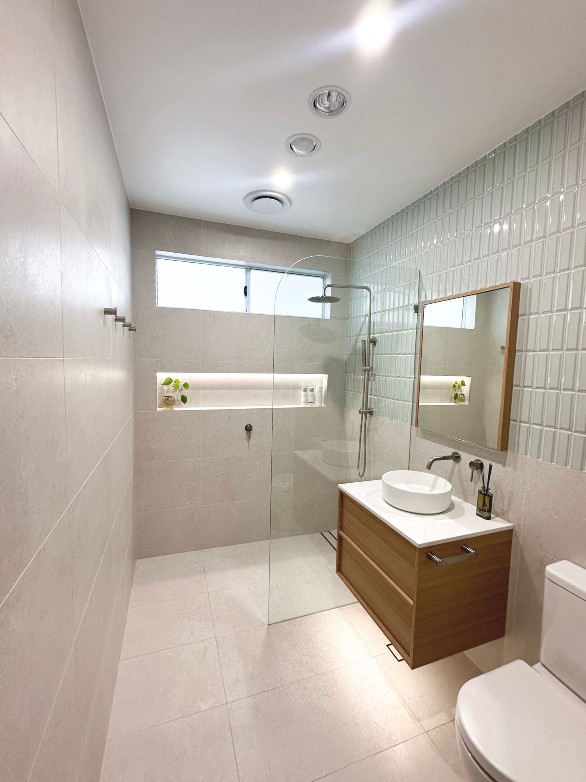  Home Electrical. A bathroom with a sink , toilet , shower and mirror. LED lighting and downlighting. 
