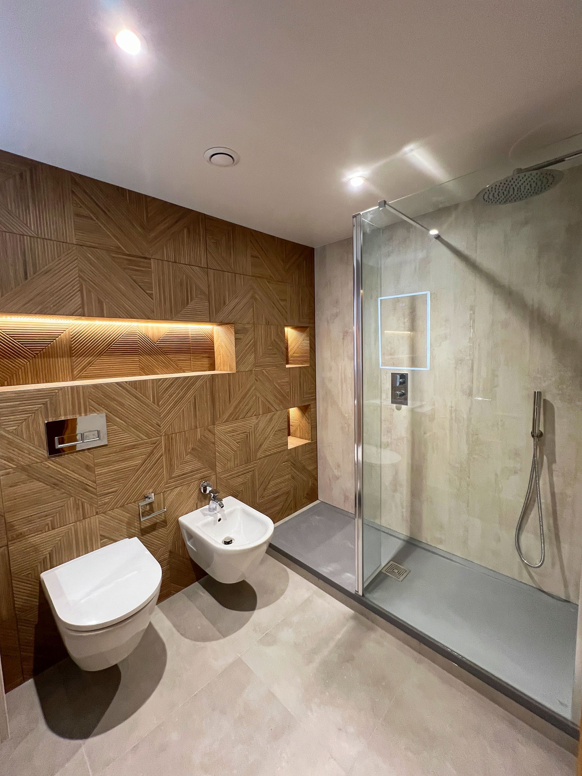 A bathroom with a bathtub , toilet and shower