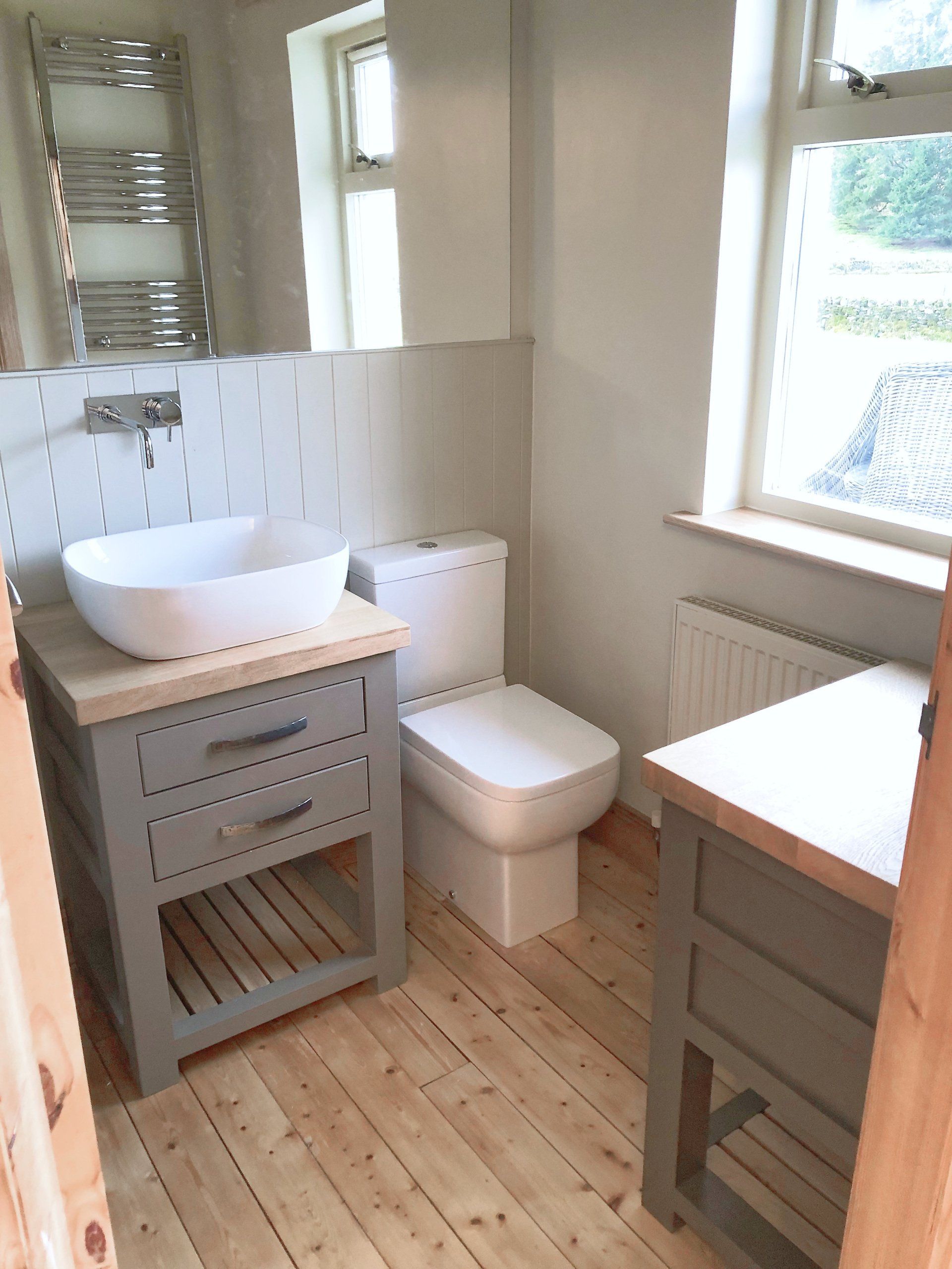 A bathroom with a sink , toilet , and mirror.